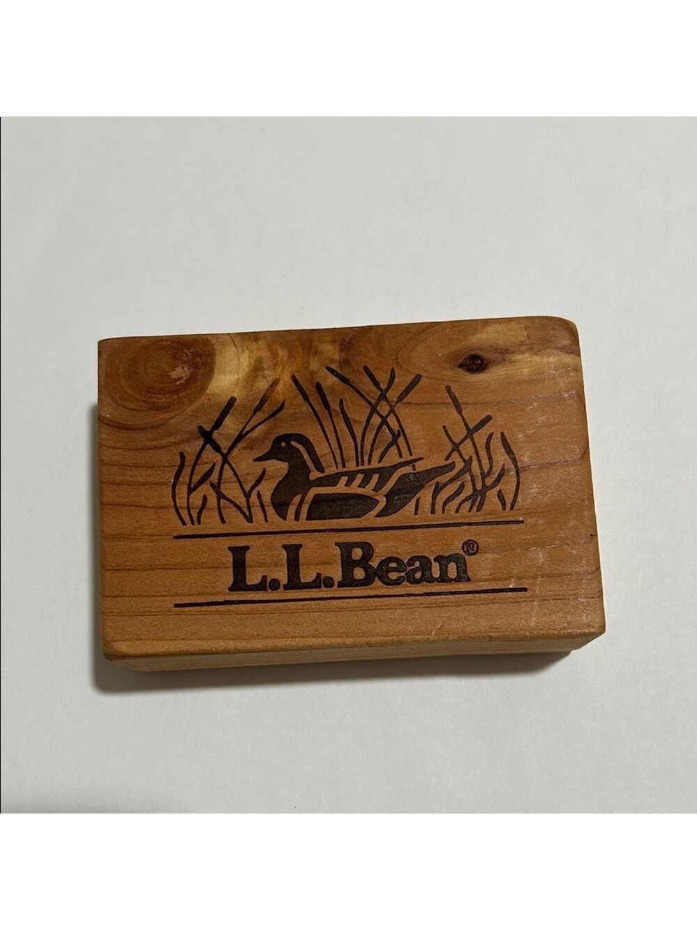 Wooden cedar block featuring L.L. Bean logo and engraved duck design. Set of 6